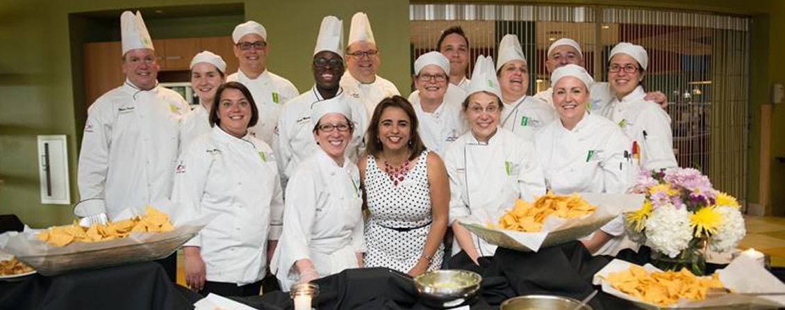 The image shows a group photo of chefs participating in a annual Aclamo Culinary Celebration.