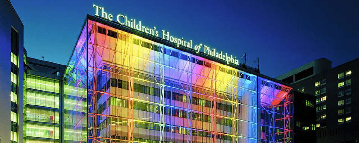 Image of “The Children Hospital of Philadelphia” with color lights displayed onto build. Representing the holiday season for the toy fundraiser.