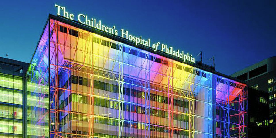Image of “The Children Hospital of Philadelphia” with color lights displayed onto build. Representing the holiday season for the toy fundraiser.
