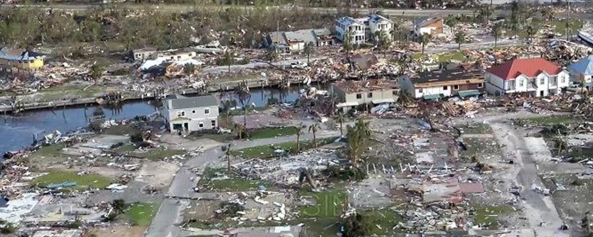 Image of destroyed town as a result of Hurricane Michael. Houses are destroyed and streets are filled with rubble.