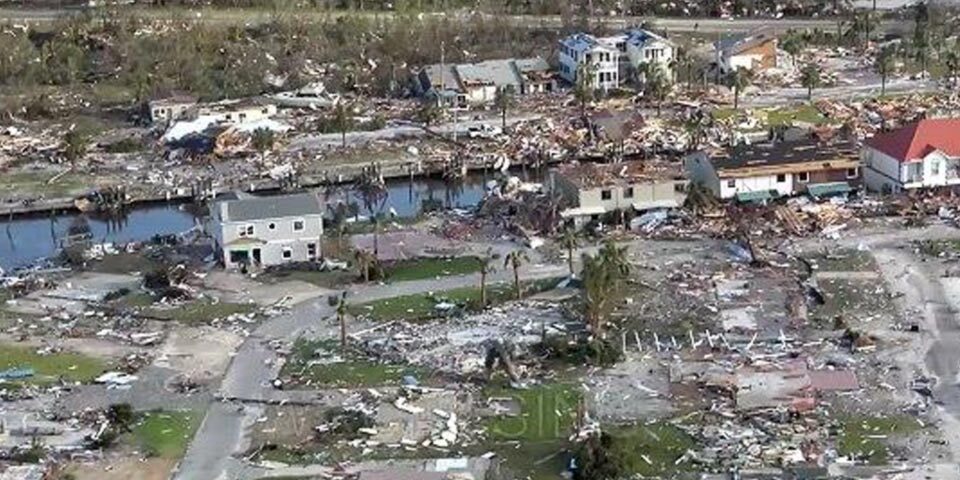 Image of destroyed town as a result of Hurricane Michael. Houses are destroyed and streets are filled with rubble.