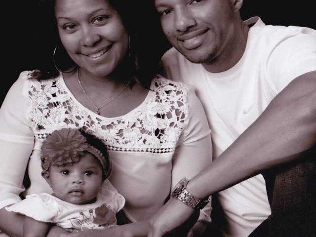 An Image of a black and white family portrait.