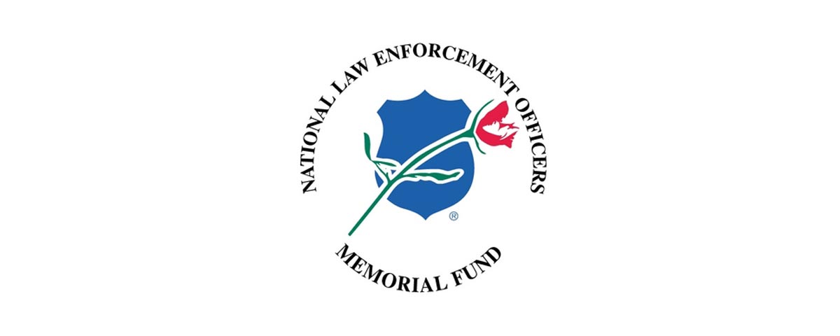 Logo for “National Law Enforcement Officers Memorial Fund”. The graphic has the title written in a circle fashion. In the center is a blue shield with a rose graphic over top.