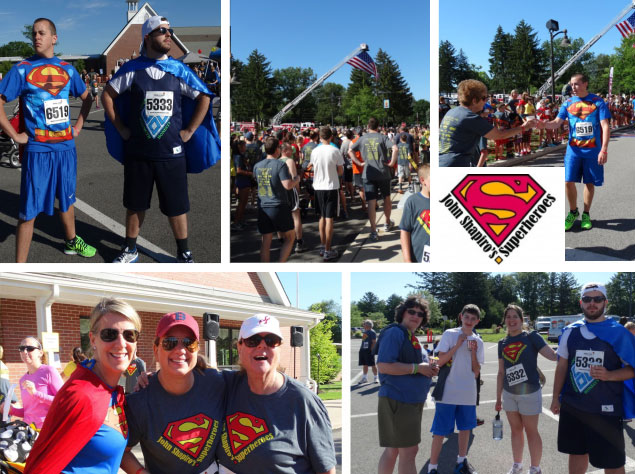 An Image of numerous runners participating in john Shapiros superhero’s 5k. a charity race where participants dress up as superman to raise awareness on brain cancer in young children.