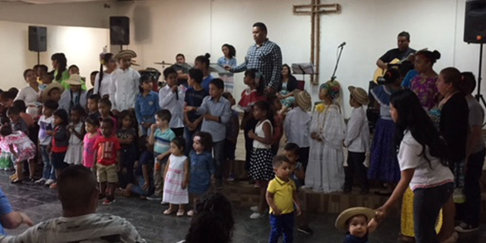 Image of large group of children in a church.