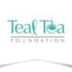 A graphic logo for Teal Tea foundation. The lettering is in teal color. The l is constructed in a ribbon shape. The e is designed to make and image of a cup of tea. Light gray text spells foundation underneath.